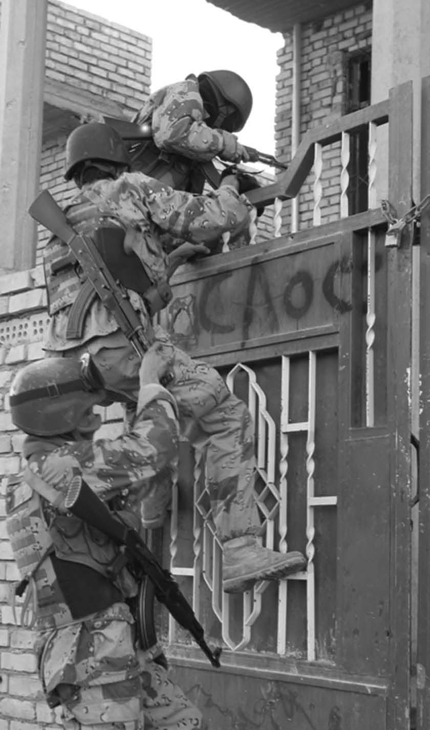 Iraqi Soldiers of the 1st Battalion, 2d Brigade, 1st Iraqi Infantry Division conduct search operations in Fallujah, Iraq, 9 December 2005.